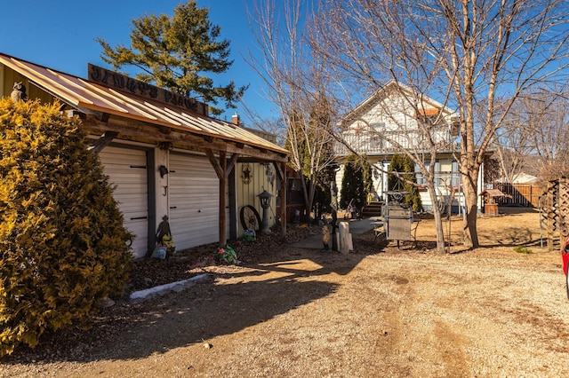 exterior space with metal roof and fence