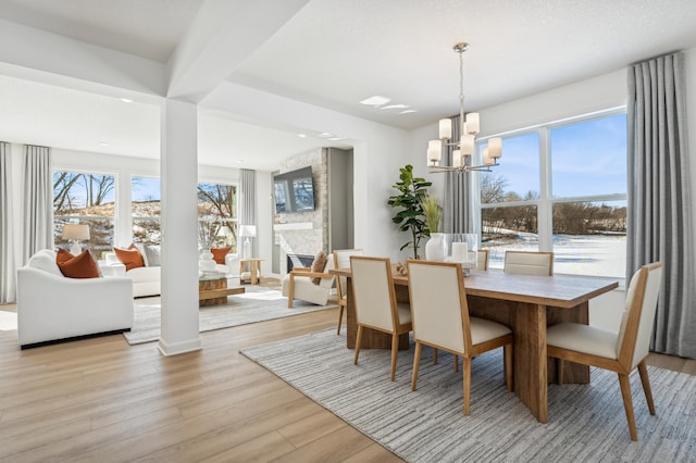 dining area with a chandelier and light wood finished floors