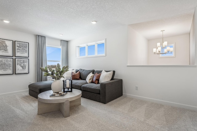 carpeted living room with a chandelier, recessed lighting, a textured ceiling, and baseboards