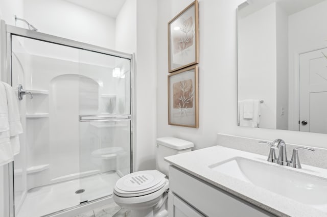 full bath with vanity, a shower stall, and toilet