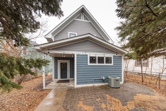 view of front of home featuring a patio area, fence, and central air condition unit