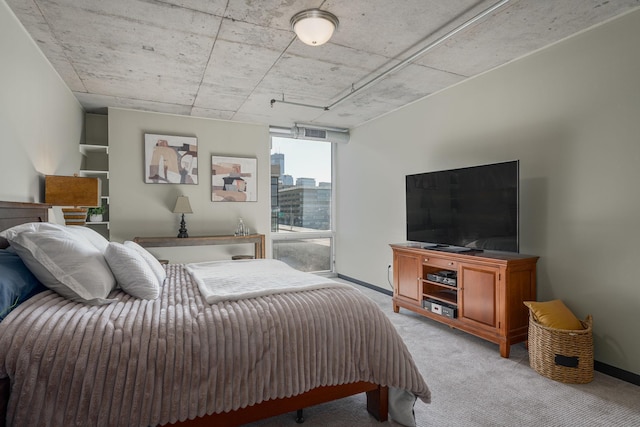 bedroom featuring light carpet and baseboards