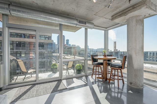 sunroom / solarium with a view of city and visible vents