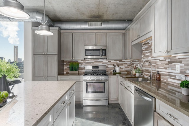 kitchen featuring appliances with stainless steel finishes, visible vents, a sink, and tasteful backsplash