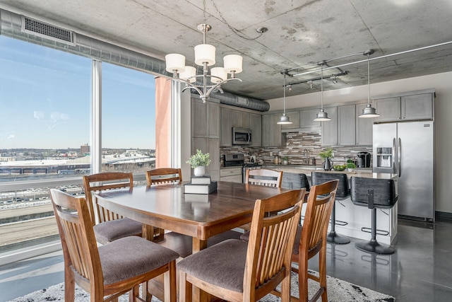 dining space with an inviting chandelier and visible vents