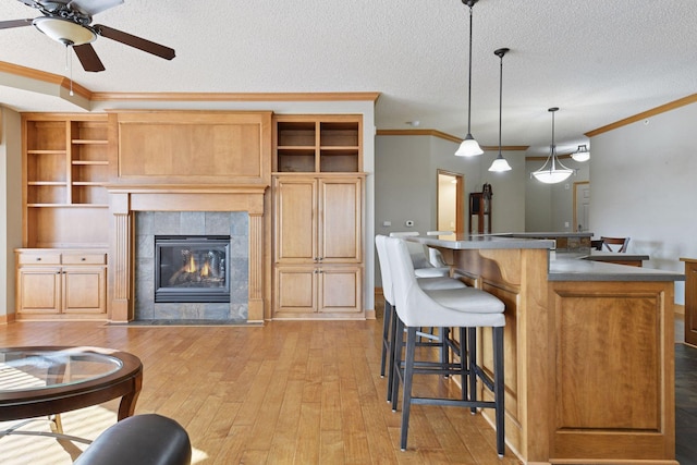 kitchen with light wood-style flooring, crown molding, and open shelves