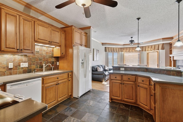 kitchen featuring white appliances, ornamental molding, a sink, pendant lighting, and backsplash