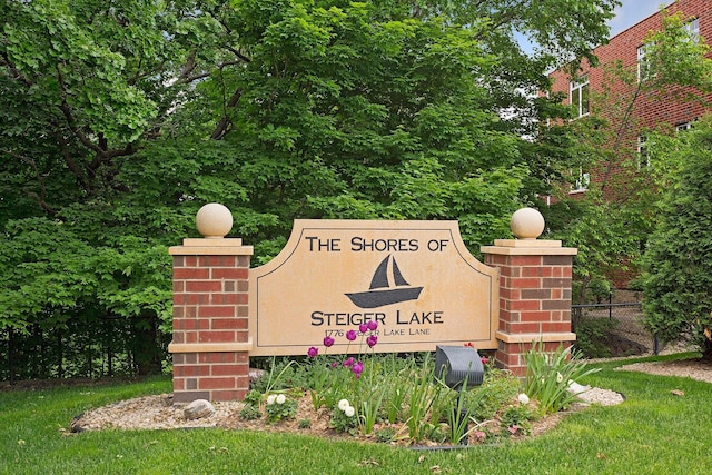 community / neighborhood sign with fence