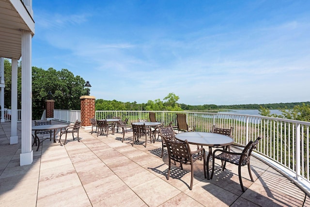 view of patio with outdoor dining space and a water view