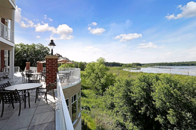 view of patio / terrace featuring a balcony and a water view