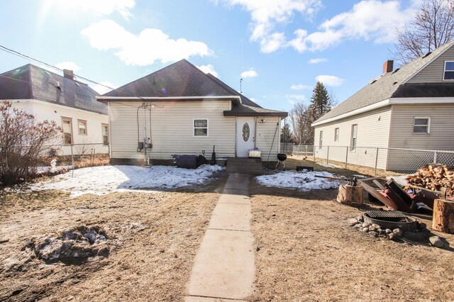 rear view of property featuring a fenced backyard