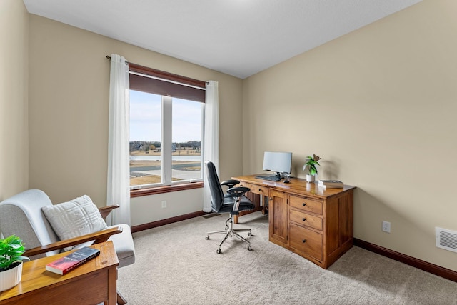 carpeted office space with visible vents and baseboards