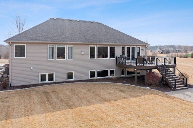 back of house featuring stairway, a wooden deck, and roof with shingles