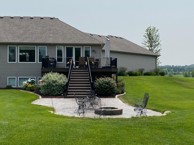 back of property with a deck, a patio, stairs, and a fire pit