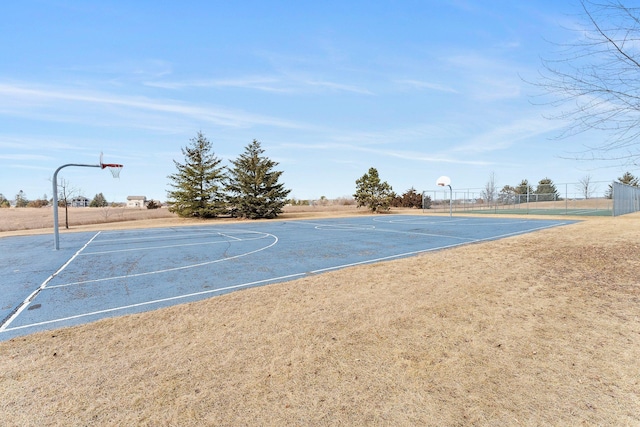 view of basketball court with community basketball court and fence