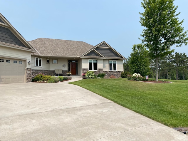 view of front of home with a front lawn, concrete driveway, stone siding, and an attached garage