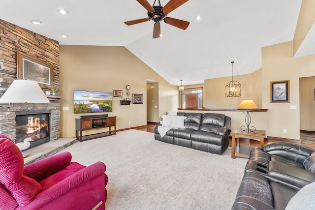 living room with baseboards, lofted ceiling, a fireplace, and ceiling fan with notable chandelier