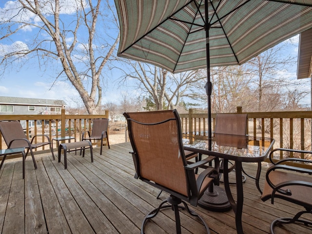 wooden terrace with outdoor dining space