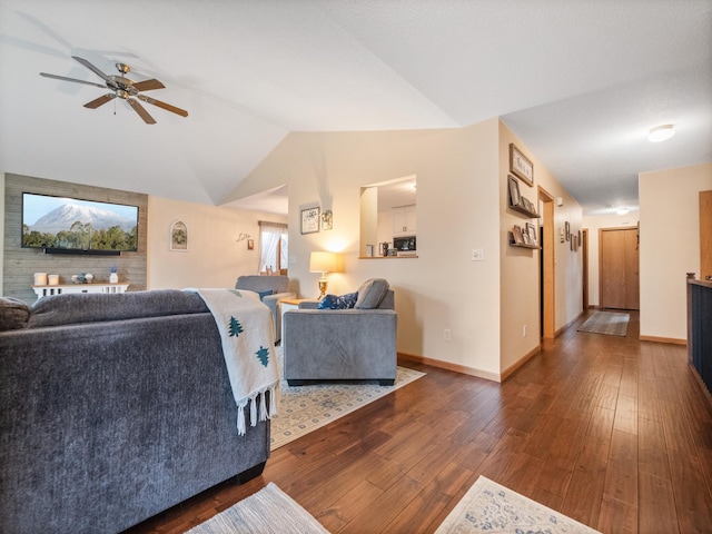 living room featuring baseboards, wood-type flooring, lofted ceiling, and a ceiling fan