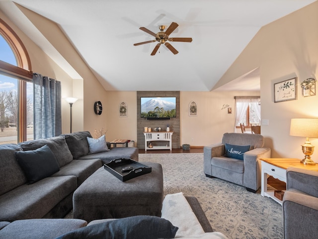 living area featuring lofted ceiling, wood finished floors, and a ceiling fan