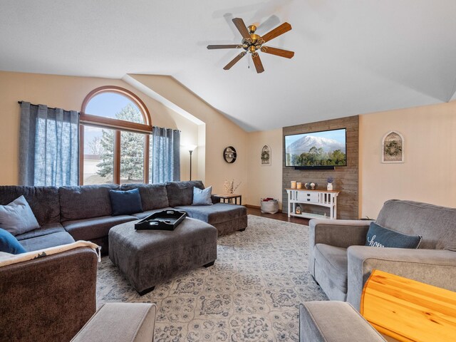 living room featuring vaulted ceiling, wood finished floors, and a ceiling fan