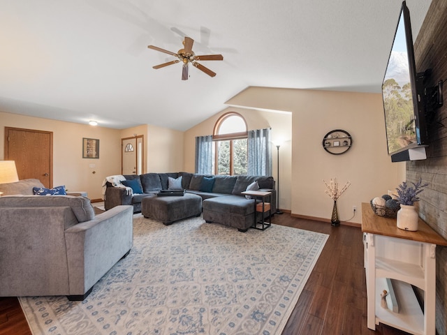 living area featuring baseboards, lofted ceiling, dark wood-style floors, and a ceiling fan