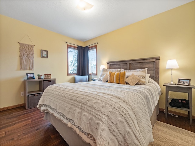 bedroom featuring dark wood finished floors and baseboards