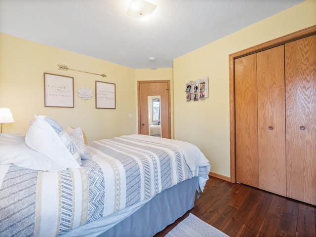 bedroom featuring a closet, baseboards, a textured ceiling, and dark wood-style floors