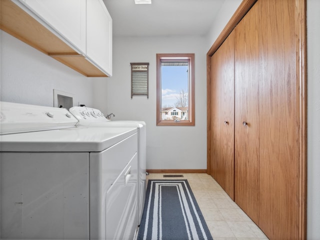 laundry room with washer and clothes dryer, cabinet space, and baseboards