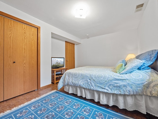 bedroom with visible vents and a closet