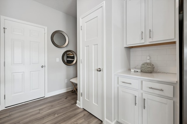 interior space featuring light wood-type flooring and baseboards