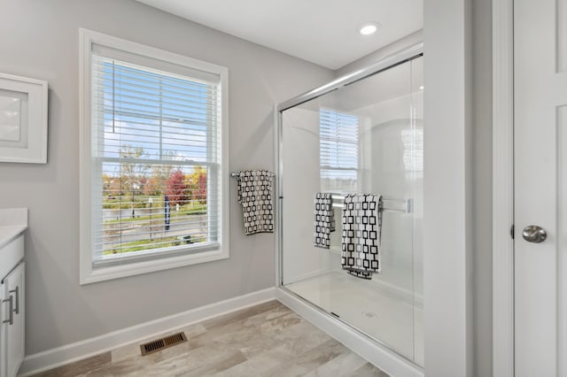 full bath with recessed lighting, visible vents, vanity, baseboards, and a shower stall