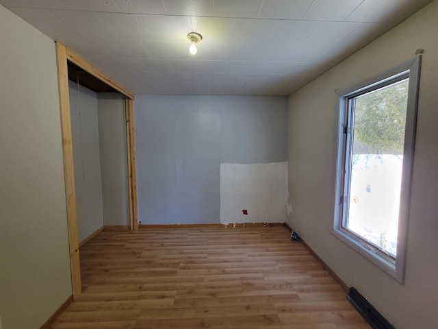 empty room with baseboards and light wood-style floors