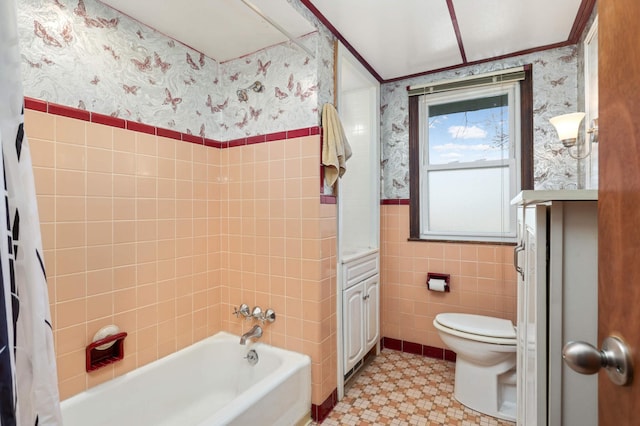 full bath featuring wallpapered walls, a wainscoted wall, toilet, tile patterned floors, and tile walls