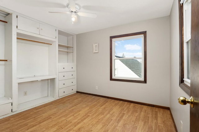 unfurnished bedroom with baseboards, light wood-style floors, and a ceiling fan