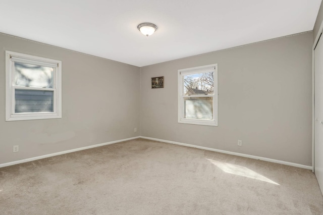 carpeted spare room with baseboards