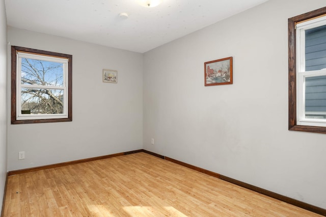 empty room featuring light wood-style flooring and baseboards