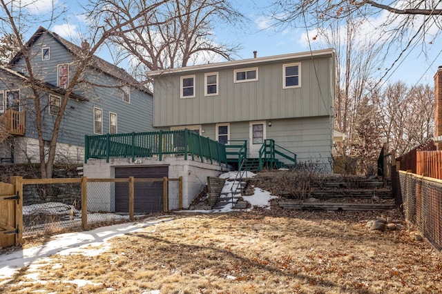 view of front of property featuring stairway, a garage, and fence