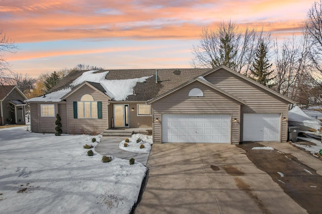 ranch-style house with an attached garage and concrete driveway