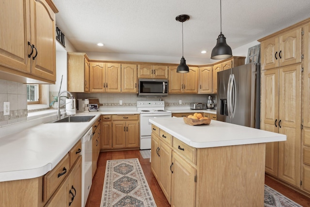 kitchen with a sink, stainless steel appliances, tasteful backsplash, and dark wood finished floors