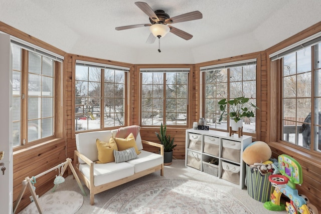 sunroom featuring ceiling fan