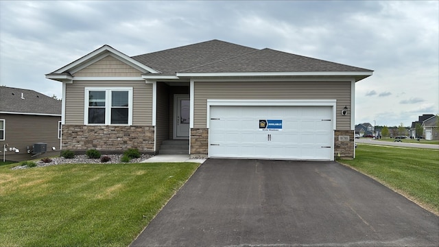 18788 Grant St NW, Elk River, MN 55330 - view of front of home featuring stone siding, asphalt driveway, a front lawn, an attached garage, and a shingled roof