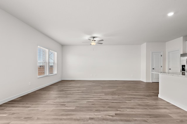 18788 Grant St NW, Elk River, MN 55330 - empty room with a ceiling fan, light wood-style flooring, and recessed lighting