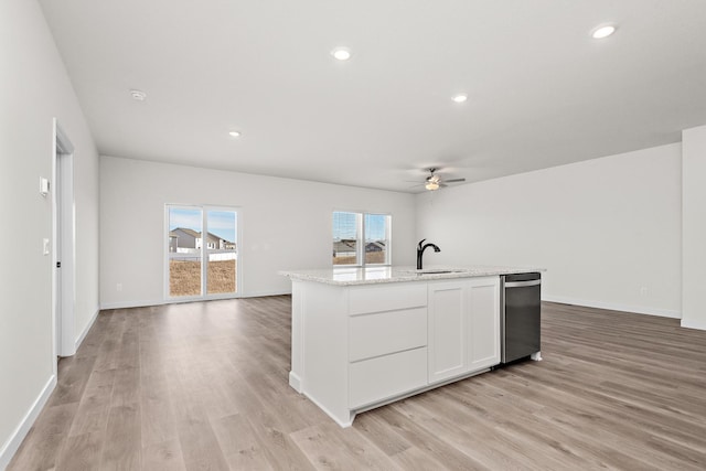 18788 Grant St NW, Elk River, MN 55330 - kitchen featuring stainless steel dishwasher, ceiling fan, open floor plan, light wood finished floors, and white cabinetry