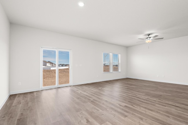 18788 Grant St NW, Elk River, MN 55330 - spare room with healthy amount of natural light, wood finished floors, and a ceiling fan