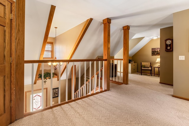 bonus room featuring lofted ceiling, an inviting chandelier, and carpet floors