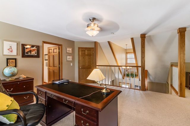 carpeted office space with ceiling fan and ornate columns