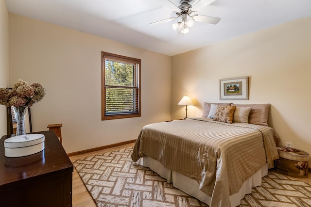 bedroom featuring a ceiling fan, light wood-type flooring, and baseboards