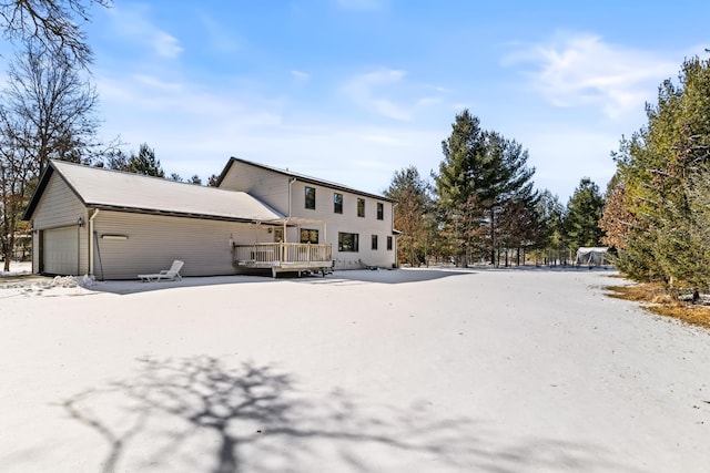 view of front of house featuring a garage and a wooden deck