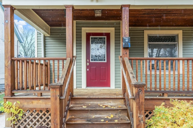 view of exterior entry with covered porch